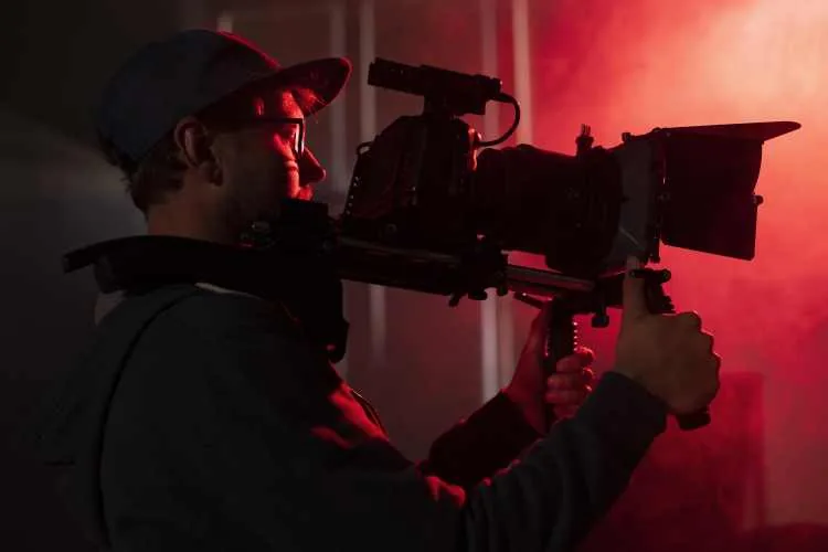 Videographer filming with a professional camera